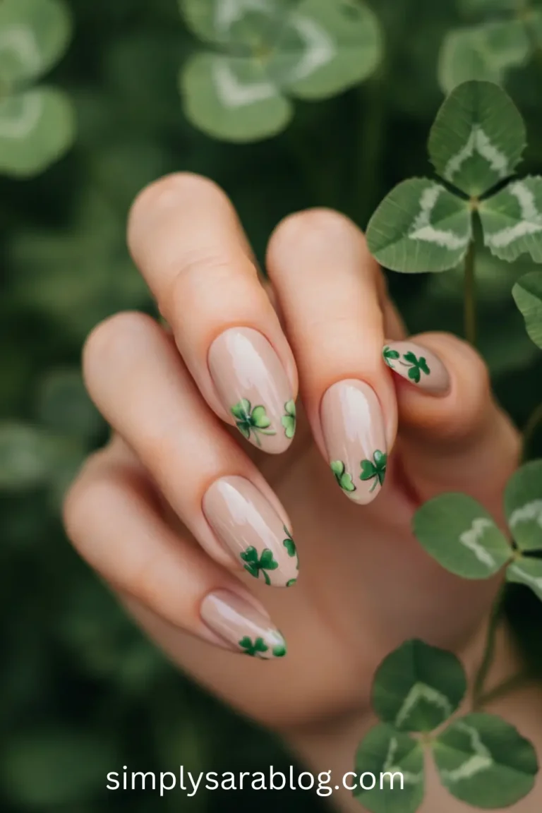 A chic green manicure with subtle white floral designs, perfect for St. Patrick’s Day celebrations." "Gradient ombre green French manicure displayed on softly squared nails for a modern holiday look." "Checkerboard green and white nail art styled with a cozy green sweater and gold accents." "Festive nails featuring delicate shamrock patterns painted over a deep green polish base." "Minimalist St. Patrick’s Day nail design with nude polish and elegant green swirl accents."